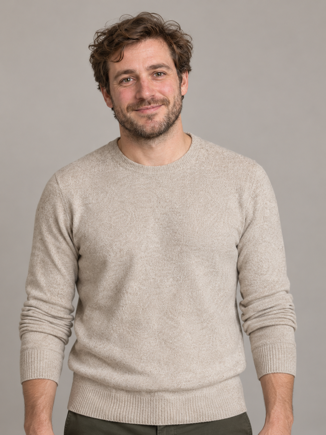 Fictional adult man with brown hair and stubble wearing an oatmeal sweater; exact input to the adjacent AI video